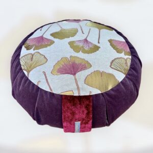 Cette image représente un zafu coussin de méditation grand modèle avec le contour violet et une assise avec feuilles de ginkgo dorées et parme
